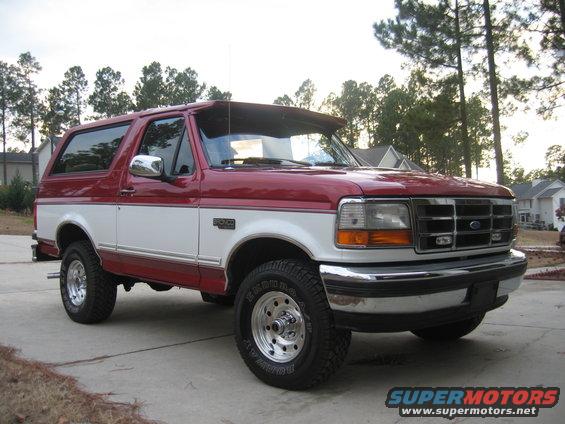Red and white Ford Bronco parked on a driveway