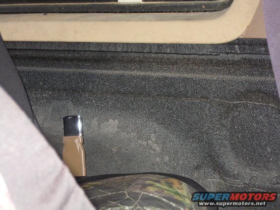Interior view of a truck bed with Line-X coating and camouflage seat cover