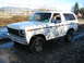 1980 Ford Bronco - This white Ford Bronco, likely from the late 1970s, is shown parked in a muddy area.