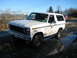 1980 Ford Bronco - This 1980 Ford Bronco is shown in a muddy, outdoor setting with power lines in the background.