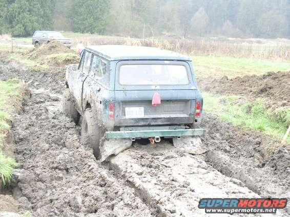 1970s International Scout II stuck in deep mud, another SUV visible in background