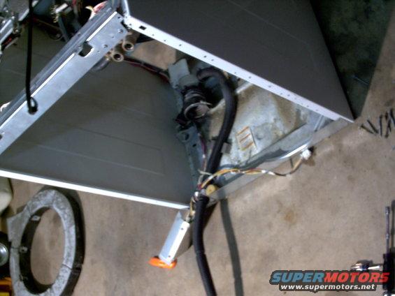 inside of a washing machine with hoses and wires