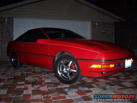 Red 1989 Ford Probe coupe parked in driveway at night