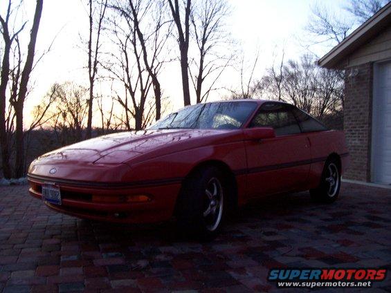 1989 Ford Probe coupe parked on brick driveway next to garage