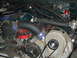 1996 Ford Bronco - Close-up of a modified engine bay a supercharger and associated plumbing.
