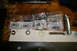 1986 Ford Bronco - Various hardware components including nuts, washers, and screws are laid out on a wooden surface.