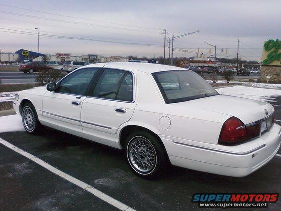 White 2000 Mercury Grand Marquis parked in a lot, rear 3/4 view