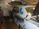 1969 Ford Torino - A 1969 Ford Torino in primer, possibly undergoing restoration, is shown in a garage setting.
