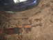 1969 Ford Torino - Two rusty leaf springs lie on the ground next to a car fender and headlight.