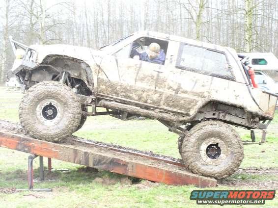 Muddy off-road vehicle on a ramp, side view