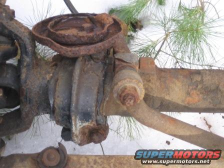 rusted front axle assembly with suspension components