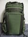 1991 Ford Bronco - A green tactical backpack with multiple straps and pockets is shown against a wall and carpeted floor.