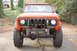 1994 Ford Bronco - Front view of an orange International Harvester Scout with off-road tires and a modified front end.