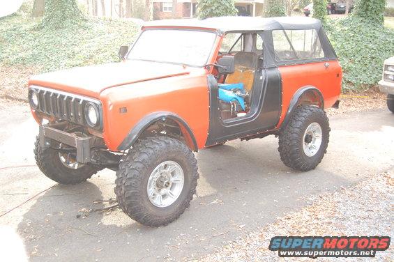 Orange and black SUV with off-road tires, doors removed