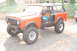 1994 Ford Bronco - This lifted SUV, possibly an International Harvester Scout, is shown with its doors removed and large off-road tires.