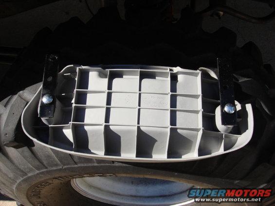 radoi109.jpg now to complete the back amp. i needed to move the spare tire out 3" so the new amp had room to breath and the spare would be in the stock location. i took an 8" steel mending plate and cut it in half. i then opened one hole to hold the stock bolts. I painted the brackets black i used 3/8 carrage bolts in the stock tire mount holes. the other holes will be the stock bolts going into the floor.