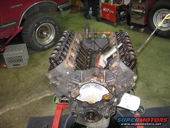 Engine block with valve covers removed, air impact wrench attached