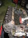 1990 Ford Bronco - Close-up view of an engine block's internal components, including valves and springs, heavily coated in oil.