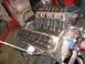 1990 Ford Bronco - Engine block with valve train components exposed, likely undergoing repair or rebuild.