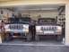 1979 Ford Bronco - Two Ford Broncos from the 1979 model year are parked inside a garage.