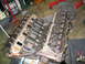 1990 Ford Bronco - Close-up view of an engine with its intake manifold removed, revealing the valve train components.