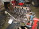 1990 Ford Bronco - Engine block assembly on a stand, showing internal components.