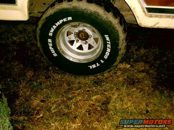 Close-up of a large off-road tire with white lettering on a vehicle's side