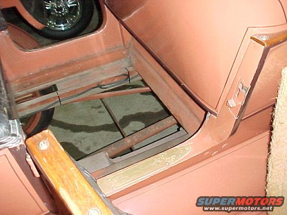 Under the floor boards in the back seat