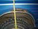 1990 Ford Bronco - A measuring tape is positioned next to the rusted wheel well of a blue vehicle.
