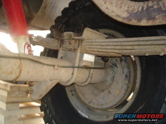 Rear axle and leaf springs with red shock absorber