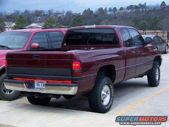 Maroon pickup truck rear view, California license plate 186 LNR, aftermarket LED tail light strip