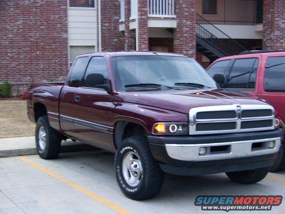 Maroon 2001 Dodge 1500 pickup truck, 3/4 front view. Chrome grille