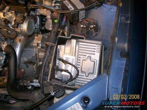 Engine control module with visible labels and wiring