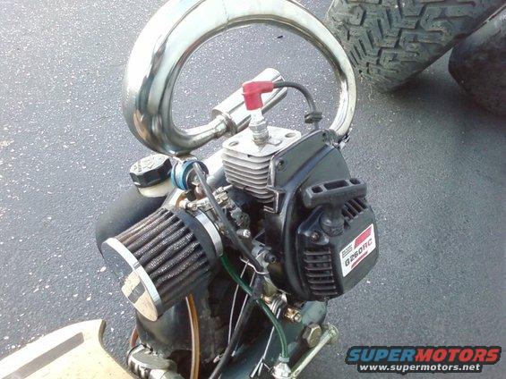 Small engine with chrome exhaust pipe, air filter, and 'G260RC' label