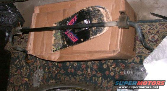 Anti-roll bar mounted over a cardboard box with a skateboard on top