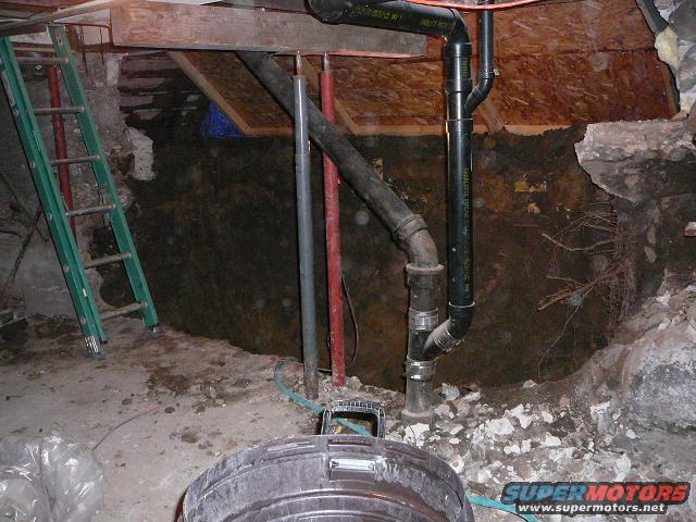 House foundation with plumbing and ladder