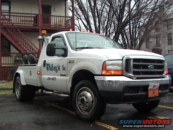 White tow truck with "Whitey's Inc." lettering and phone number