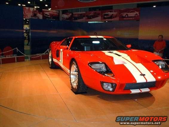 Red 2005 Ford GT with white racing stripes, 3/4 front view