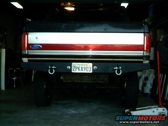 1989 Ford Bronco rear view showing a custom black bumper with D-rings and a California license plate reading 2PKA903