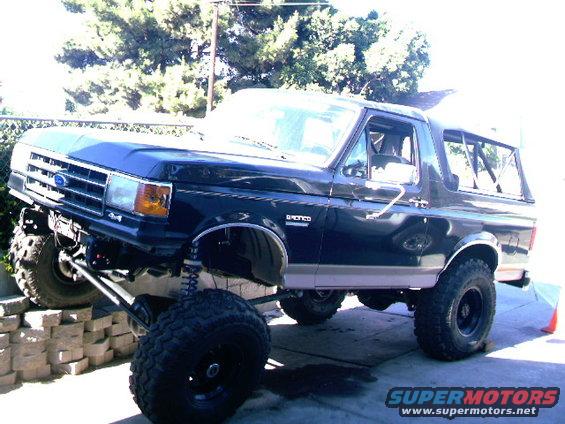 Black lifted 1989 Ford Bronco with large tires and custom suspension