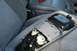1996 Ford Bronco - The interior overhead console of a vehicle is shown disassembled, revealing its internal wiring and components.