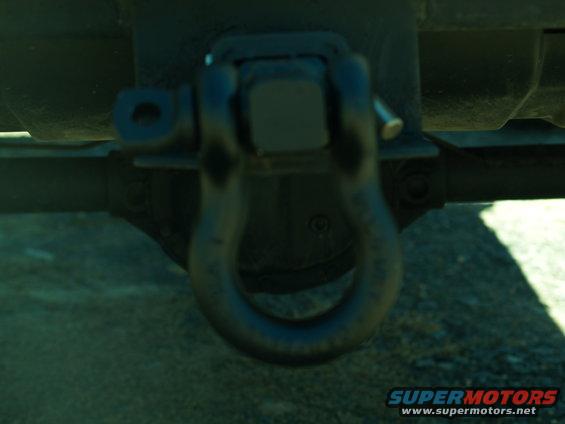 Tow hitch shackle on vehicle frame