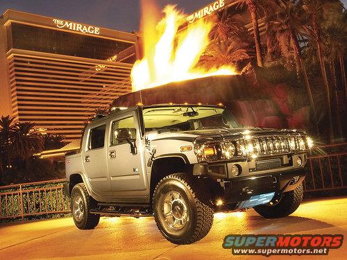 Silver Hummer H2 SUT parked in front of The Mirage hotel with flames erupting behind it
