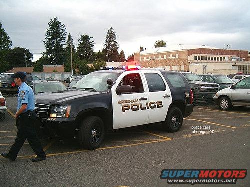 Black and white police SUV with "Gresham Police" text, parked in a lot