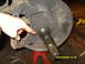 1989 Ford Bronco - Vehicle spindle and brake rotor assembly being worked on, with a hand pointing. Date stamp visible: 10/02/2008.