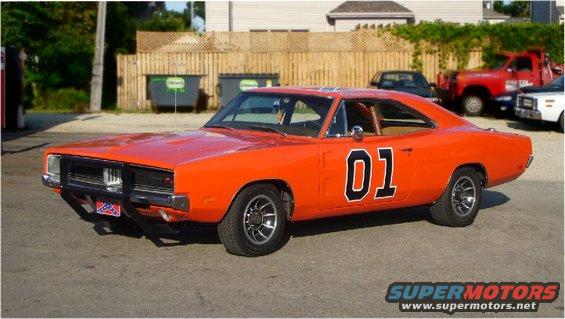 Orange 1970 Dodge Charger with black trim and the number 01 on the door, parked on asphalt