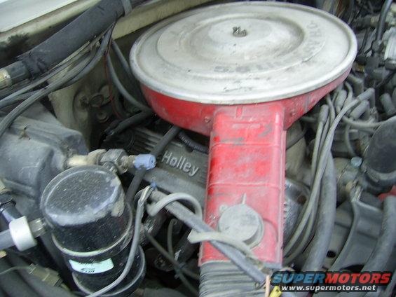 Engine bay with Holley valve covers and a red air cleaner housing