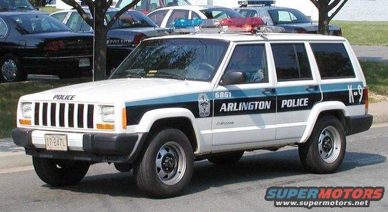 White Jeep Cherokee police SUV with "Arlington Police" text and K-9 designation