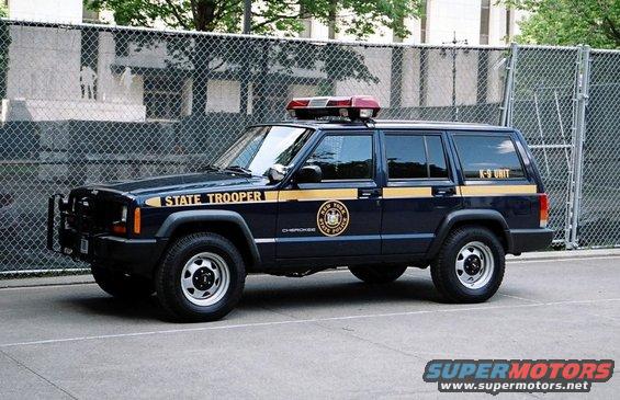 Dark blue Jeep Cherokee with "STATE TROOPER" and "K-9 UNIT" markings, and a New York State Police emblem