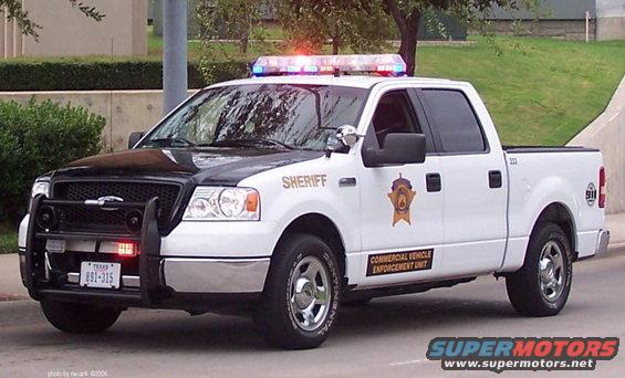 White and black sheriff's pickup truck with light bar and push bar